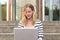 Cute woman in striped shirt typing on computer