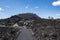 Cute woman takes a hike along the Trail of Molten Lands in Lava Lands Newberry Volcano National Monument in Oregon