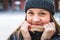 Cute woman wearing a beanie in winter. Happy and smiling person