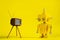 Cute yellow handmade robot on a yellow background with