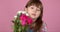 Cute young adorable girl holding and smell bouquet of fresh flowers