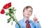 Cute young affectionate child whearing a shirt and a tie holding roses has a gift idea