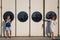 Cute young beautiful hipster couple at port, on the white wall with big portholes background, happy smiling outdoor portrait