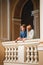 Cute young beautiful hipster couple travelling Europe, standing at the Opera House balcony