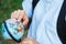 Cute, young boy in blue shirt with backpack and workbooks holds globe in his hands in front of his school. Education