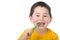 Cute young boy brushing his teeth isolated