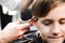 A cute young boy getting a haircut