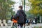 Cute young boy plays basketball on street playground. Teenager with orange basketball ball outside. Hobby, active lifestyle, sport