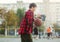 Cute young boy plays basketball on street playground. Teenager with orange basketball ball outside. Hobby, active lifestyle, sport