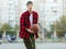 Cute young boy plays basketball on street playground. Teenager with orange basketball ball outside. Hobby, active lifestyle, sport