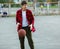 Cute young boy plays basketball on street playground. Teenager with orange basketball ball outside. Hobby, active lifestyle, sport