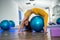 cute young brunette part-time fitness trainer doing beautiful fitness exercises in the gym.