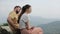 A cute young caucasian couple cuddling, hugging on the top of a mountain. Close view. Nepal. Landscape. Honeymoon.