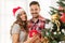 Cute, young couple decorating a Christmas tree