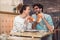 Cute young couple having a good time together and eating food in cafe