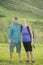 Cute young couple hiking together on a beautiful mountain hillside