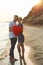 Cute young couple with red heart on sea shore