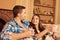 Cute young couple siting together with cups and smiling