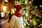 Cute young girl admiring Christmas lights and decorations on the streets of Vilnius, Lithuania. Child admiring decorated Christmas