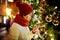 Cute young girl admiring Christmas lights and decorations on the streets of Vilnius, Lithuania. Child admiring decorated Christmas