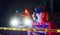 Cute young girl with curly hair and in hat standing outdoors near police line tape. Conception of crime or riot