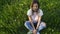 Cute young girl dressed in pink top and ripped jeans