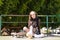 Cute young girl with heterochromia and punk style sitting with her skateboard next to her