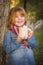 Cute Young Girl Holding Cocoa Mug with Marsh Mallows Outside