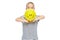 Cute young girl in stripped T-shirt holding yellow balloon with smiley face. Portrait of happy child with balloon.