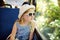 Cute young girl traveling by train on summer day. Child sitting by the window of railway wagon and looking outside