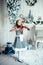 Cute young girl with violinl in christmas decoration room.