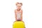 Cute young girl in white shirt, pink shorts and sunglasses stand near yellow suitcase