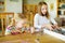 Cute young girls playing puzzles at home. Children connecting jigsaw puzzle pieces in a living room table. Kids assembling a