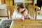 Cute young girls playing puzzles at home. Children connecting jigsaw puzzle pieces in a living room table. Kids assembling a