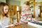 Cute young girls playing puzzles at home. Children connecting jigsaw puzzle pieces in a living room table. Kids assembling a