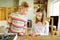 Cute young girls playing puzzles at home. Children connecting jigsaw puzzle pieces in a living room table. Kids assembling a