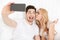 Cute young loving couple make selfie
