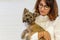 Cute young mini yorkshire terrier in the arms of a brunette woman