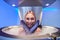 Cute young woman in cryosauna booth