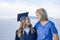 Cute Young woman in her graduation cap and gown celebrating with her mom