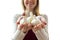 Cute young woman holding cloves of garlic in both hands on white