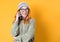 Cute young woman on the phone, isolated on yellow background. Woman using the smart phone