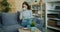 Cute young woman reading book and drinking tea indoors in cozy house