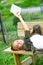 Cute young woman relaxing on a wooden bench