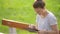 Cute young woman with tablet in the park, beautiful woman using a tablet on a bench in the garden, young female student