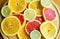 Cuted citrus fruits background. Mixed fruits background. Fruit salad