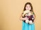 Cutest ever. Kid little girl carefully hug soft toy teddy bear beige background. Tender attachments. Small girl hold