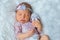 Cutest newborn girl sleeping sweetly on photosession