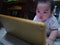 Cutie asian male baby very serious and look at tablet