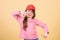 Cutie in cap. Kids fashion. Girl cute child wear cap or snapback hat beige background. Little girl wearing bright